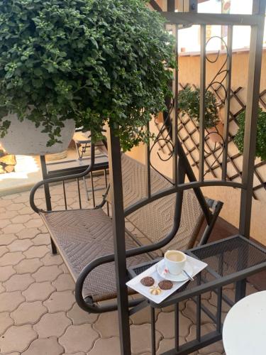 a chair with a plate of cookies and a cup of coffee at Casa Boem in Mogoşoaia