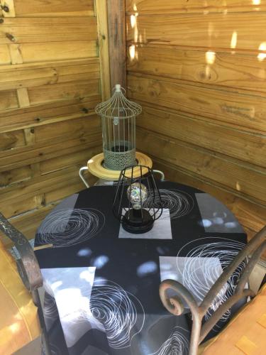 a table in a room with a lantern on a table at DEPENDANCE PRIVEE - HALTE ROUTE in Le Thor