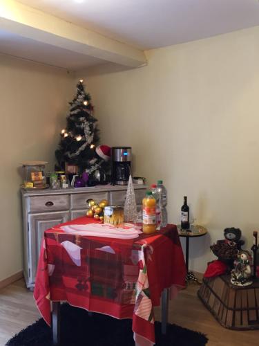 a kitchen with a christmas tree and a table at DEPENDANCE PRIVEE - HALTE ROUTE in Le Thor