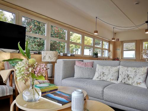 a living room with a couch and a table at Solar da Castanha - Forest House in Manteigas
