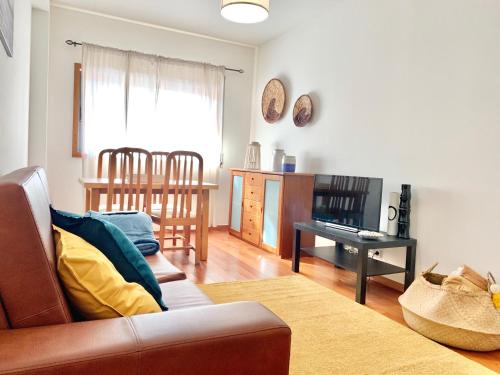a living room with a couch and a table at The University of Minho-Campus Gualtar Apartment 1 in Braga