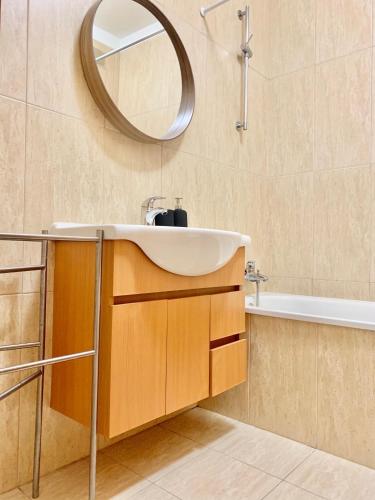 a bathroom with a sink and a mirror at The University of Minho-Campus Gualtar Apartment 1 in Braga