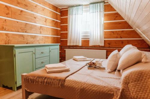 a bedroom with a bed in a room with wooden walls at Kolíska pokoja in Osturňa