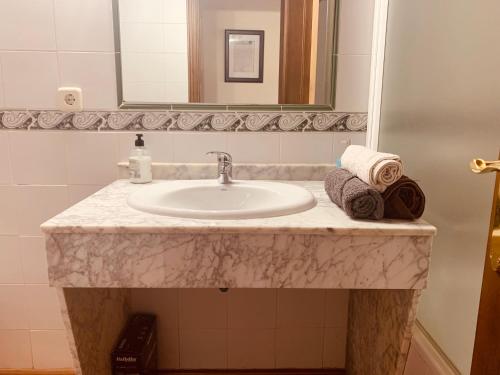 a bathroom counter with a sink and a mirror at Casa Román II in Riaza