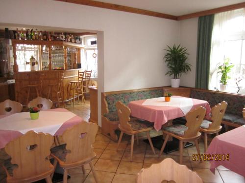 ein Restaurant mit zwei Tischen und Stühlen in einem Zimmer in der Unterkunft Hotel Haus Marienthal in Zwickau