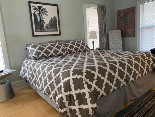 a bedroom with a bed with a brown and white comforter at St Petersburg Vacation Rentals in St Petersburg