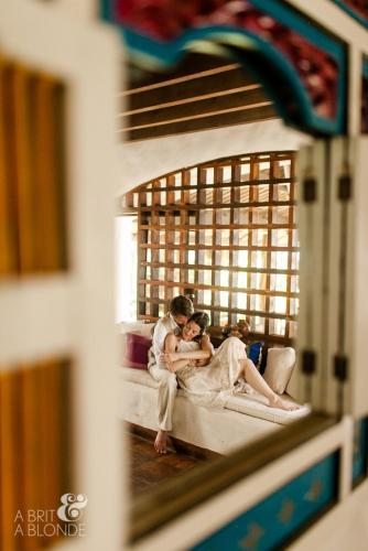 a bride and groom are sitting on a couch at Sueño del Mar Beachfront Hotel in Tamarindo