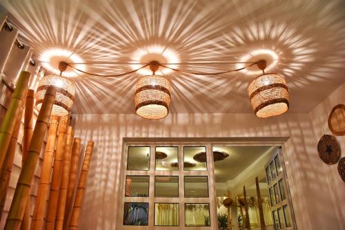 a room with three lights hanging from the ceiling at Angelos Design Suites in Patitiri