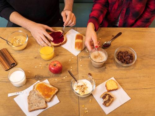 a person is making food on a wooden table at hotelF1 Mulhouse Centre Ouest in Mulhouse
