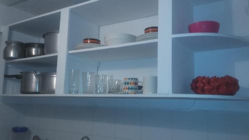 a white cabinet with bowls and dishes on it at Aptos Majos centro in San Andrés