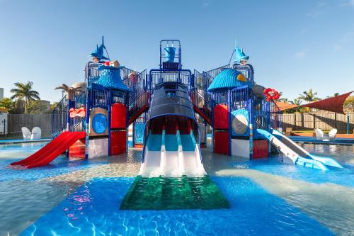 a water park with a slide in the water at Oaks Sunshine Coast Oasis Resort in Caloundra
