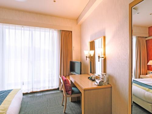 Ένα ή περισσότερα κρεβάτια σε δωμάτιο στο HOTEL AreaOne KoshikiIsland