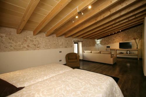 a bedroom with a bed and a living room at Sa Posada in Porreres