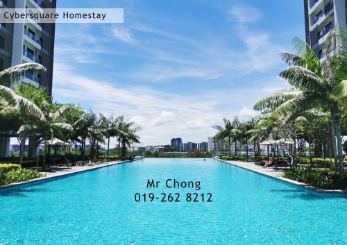 a large swimming pool with palm trees in a resort at Cybersqaure Studio Suites with Netfilx @10 min walking distance to McD in Cyberjaya