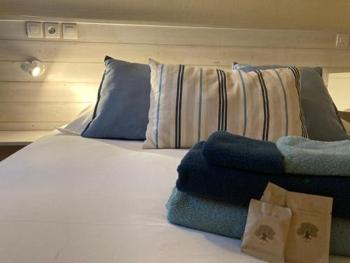 a bed with blue and white pillows on it at Résidence Thibaud in Toulouse