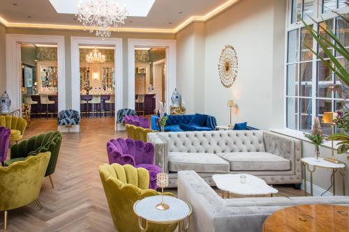 a lobby with couches and tables and chairs at Cork's Vienna Woods Hotel & Villas in Cork
