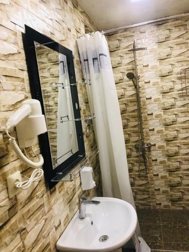 a bathroom with a sink and a shower at Arm Hotel in Yerevan