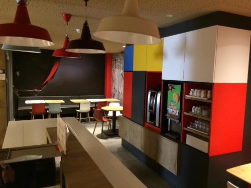 a restaurant with colorful walls and tables and chairs at Hotel ibis Braga in Braga