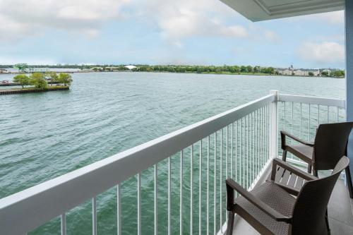 two chairs on a balcony looking out over the water at Holiday Inn Kingston - Waterfront by IHG in Kingston