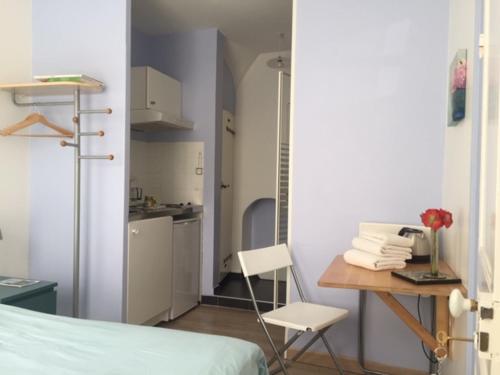 Cette chambre comprend un lit, une table et une cuisine. dans l'établissement Chambre Saint-Sauveur, aux Andelys