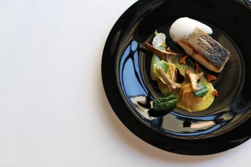 a plate of food with a sandwich and a crab at Shangri-La Qaryat Al Beri, Abu Dhabi in Abu Dhabi
