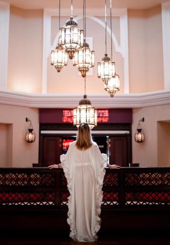 a woman in a white dress standing in a church at Shangri-La Qaryat Al Beri, Abu Dhabi in Abu Dhabi