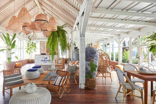 a living room with chairs and a table and someitures at The Peri Hotel Hua Hin in Hua Hin
