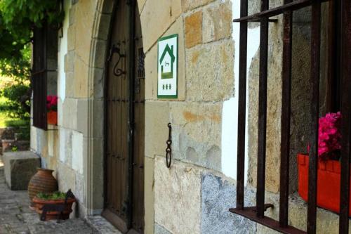 a building with a sign on the side of it at Casa rural Mertxenea Landetxea in Elcano