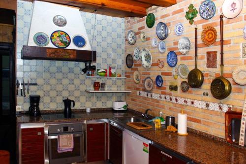 a kitchen with plates hanging on the wall at Casa rural Mertxenea Landetxea in Elcano
