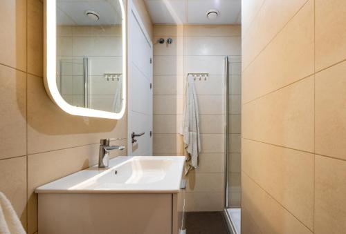 a bathroom with a sink and a mirror at Apartamento Soho Málaga in Málaga