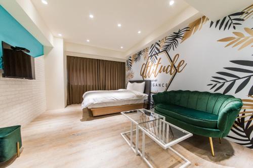 a bedroom with a green couch and a bed at Lady M Luodong in Luodong