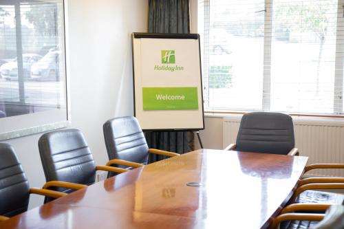 a conference room with a table and chairs at Holiday Inn Ashford - North A20 by IHG in Ashford