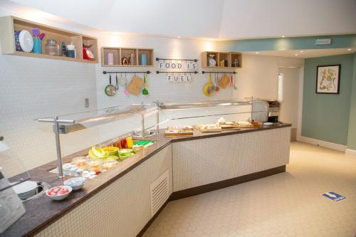 a buffet line in a restaurant with food at Holiday Inn Ashford - North A20 by IHG in Ashford