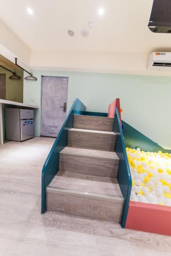 a staircase in a room with a wall of balls at Lady M Luodong in Luodong