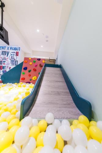 a play room with a climbing wall and balls at Lady M Luodong in Luodong