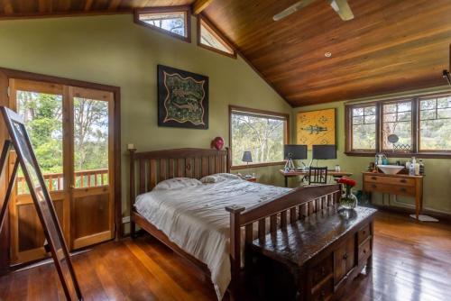 a bedroom with a bed and a wooden ceiling at The Getaway Roleystone in Roleystone