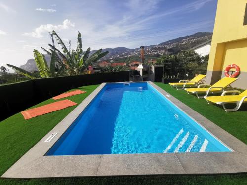 a swimming pool on the roof of a house at CASA DOS AVÓS Apartments with Pool in Funchal in Funchal