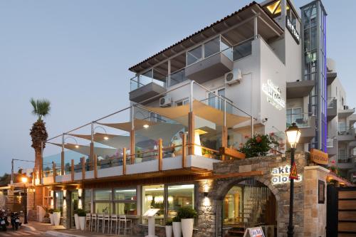 a large white building with a balcony at Elounda Akti Olous (Adults Only) in Elounda