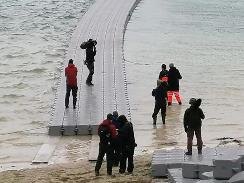 a group of people standing on a bridge over the water at The Fisherman's Snug self catering North Uist in Paible