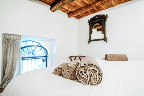 a bed with towels on it with a window at House Of Dreams - The House Of Travelers in Como