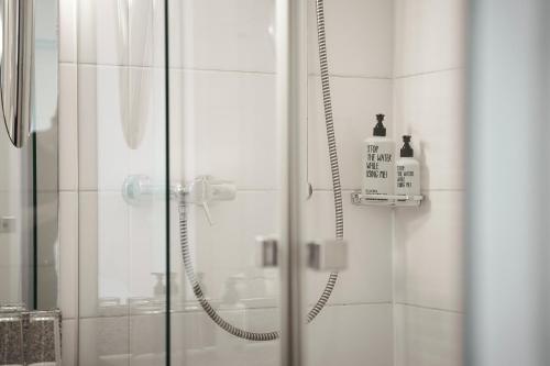 a bathroom with a shower with a glass door at Parkhaus Hügel in Essen