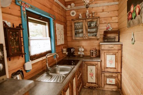 a kitchen with a sink and a window at Sielska Chyża in Rzepedż