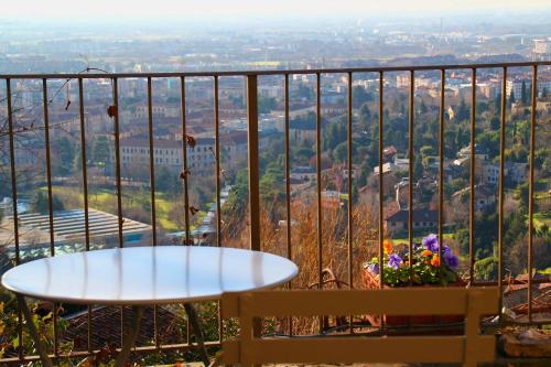 
a dining room table with a balcony overlooking the ocean at Bed & Breakfast Sant'Erasmo in Bergamo
