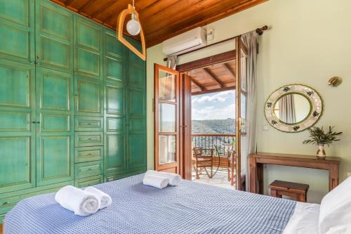 a bedroom with a bed with towels on top of it at Villa Peparethos in Stafylos