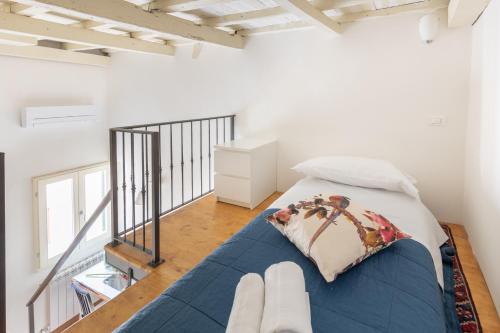 a bedroom with a blue bed in a white room at Il Civettino - appartamento nel centro di Firenze in Florence