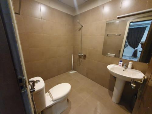 a bathroom with a toilet and a sink at Executive 3 Bedrooms Apartment In Bahria Town in Rawalpindi