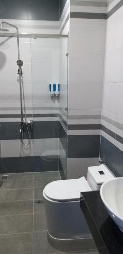 a bathroom with a shower and a toilet and a sink at Garden House Côn Đảo in Con Dao