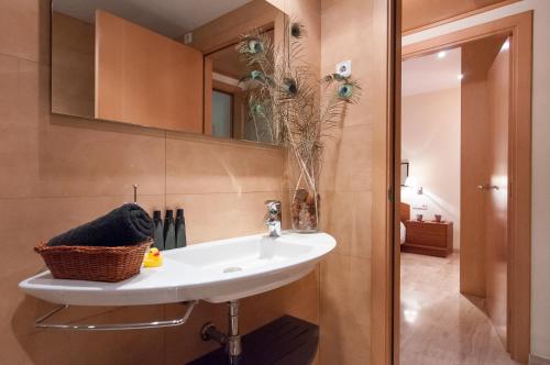ein Badezimmer mit Waschbecken und Spiegel in der Unterkunft BizFlats Garden House in Barcelona