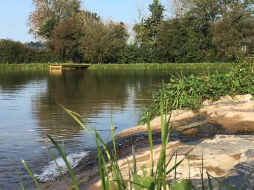a body of water with a dock in the middle at Little Barn, Greendale Farm in Barnstaple