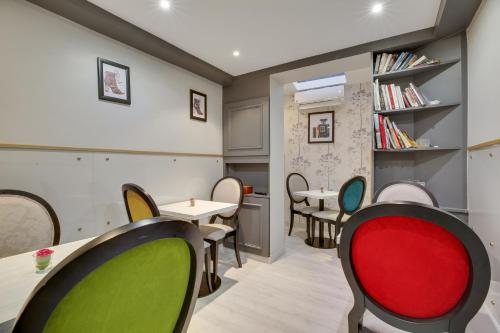 une salle d'attente avec des chaises et des tables dans l'établissement Hotel Riviera Elysees, à Paris
